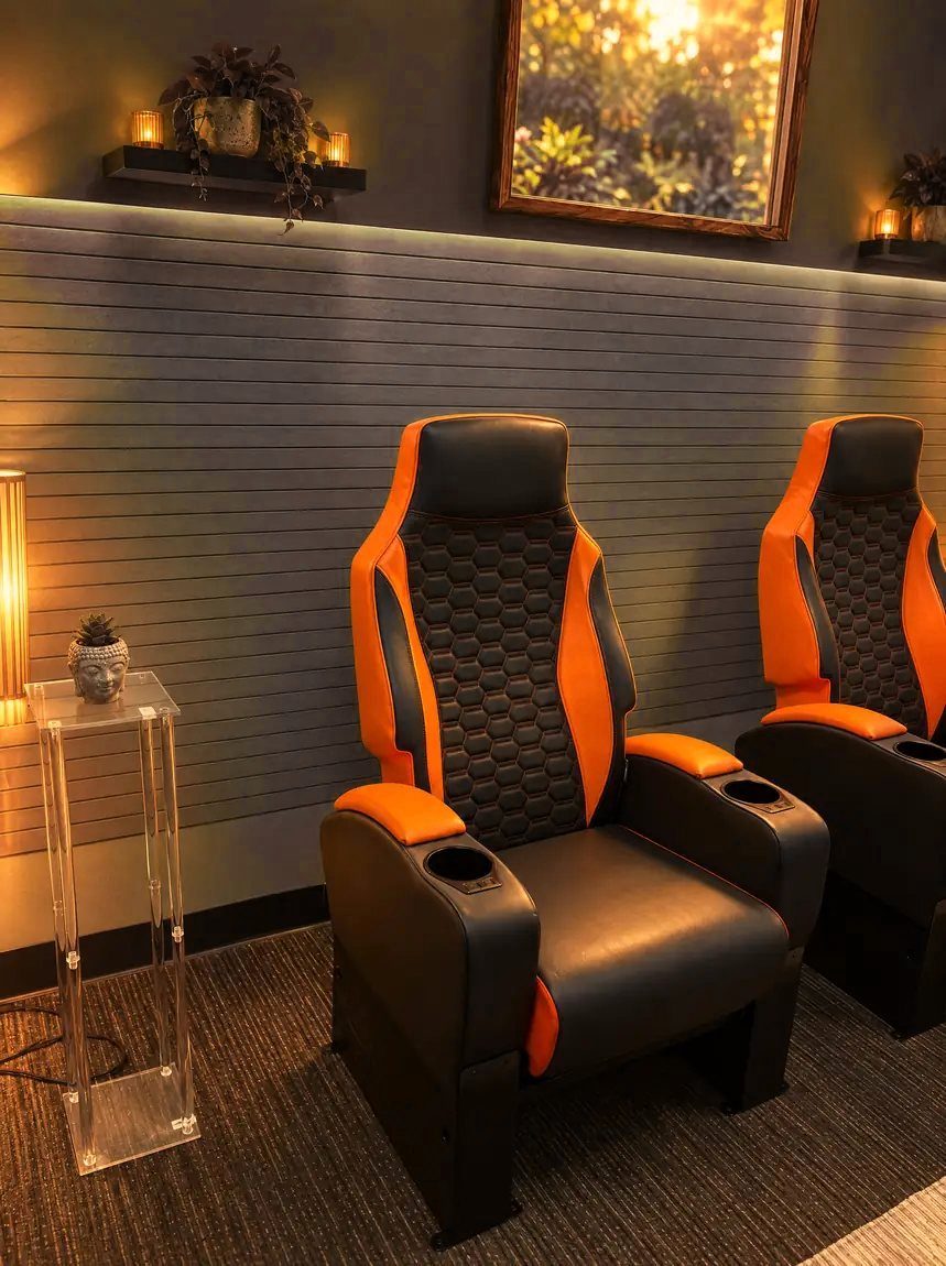 A single recliner with cup holders in warm light